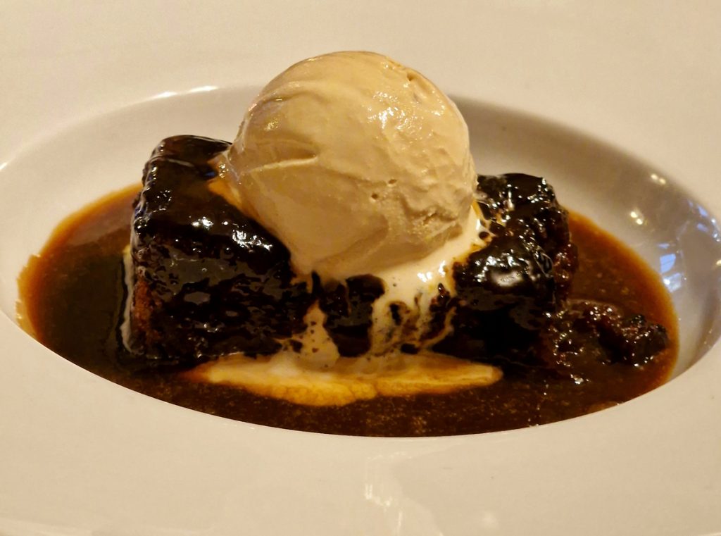 Sticky toffee pudding with melting ice cream