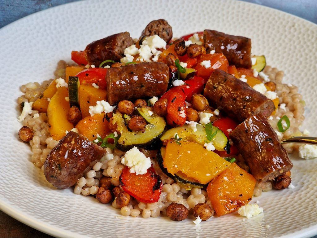 Lamb Merguez sausages with giant couscous and roasted vegetables