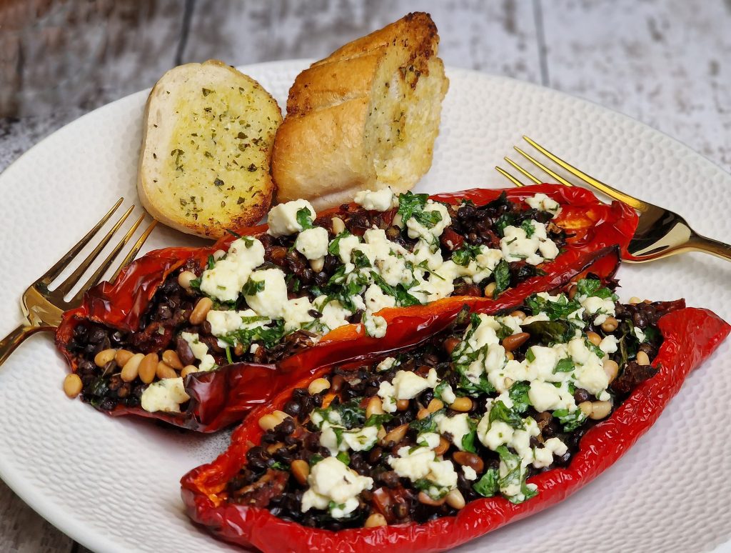 Stuffed Romano peppers with lentils, tomatoes, feta and garlic bread